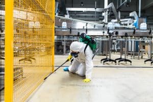 A worker conducting some pest control in a factory